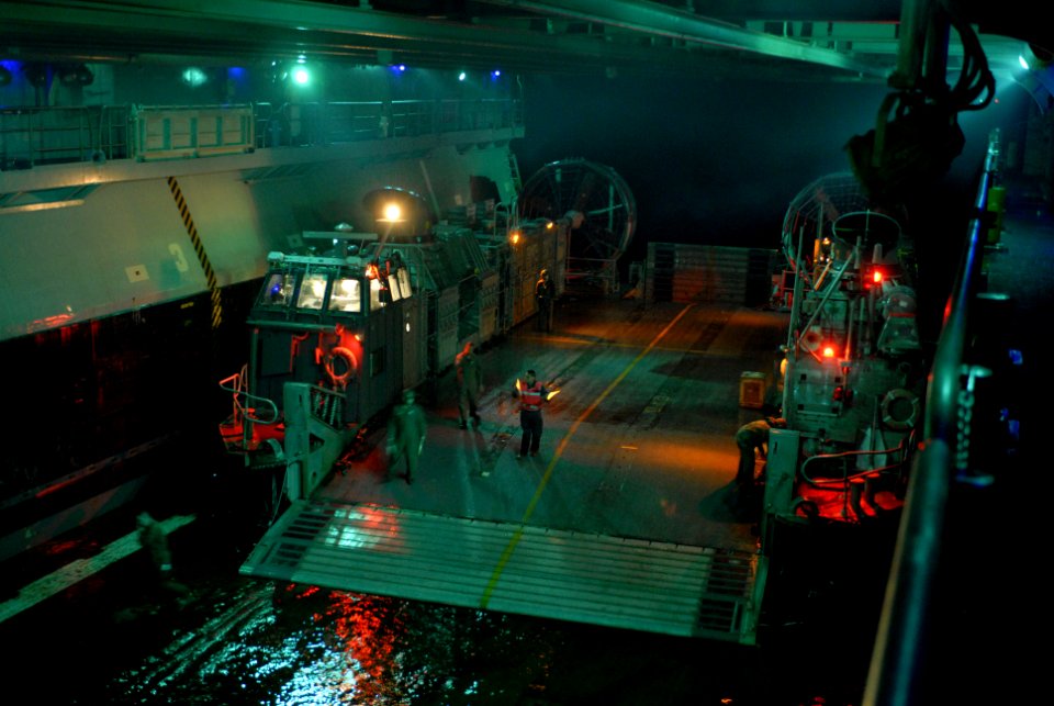 US Navy 070620-N-4010S-081 A landing craft air cushion (LCAC) arrives in the well deck of amphibious assault ship USS Essex (LHD 2) to onload Marines and their equipment during a nighttime beach assault