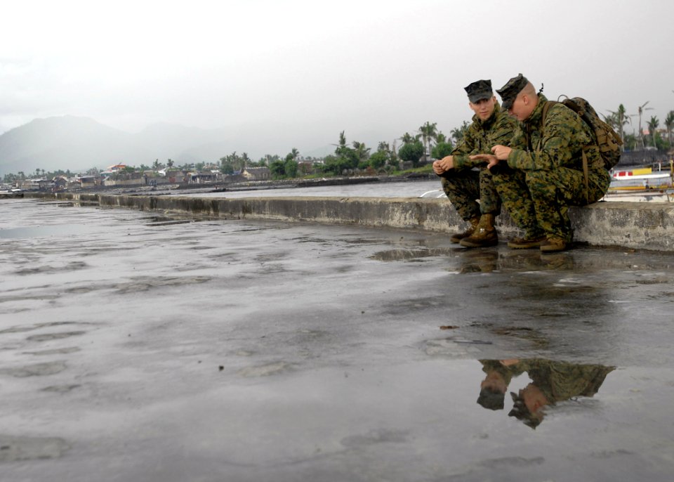 US Navy 070623-N-4954I-365 Cpl. Zachary Wendt and Cpl. Bobby Sullivan, with the U.S. Marine Corps Forces Pacific Band, share a break in the action between performances in Tabaco City