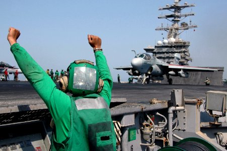 US Navy 070622-N-0890S-048 Aviation Boatswain's Mate (Equipment) 3rd Class Eduardo Villagomez stands the deck edge watch as a EA-6B Prowler, assigned to the Black Ravens of Tactical Electronic Warfare (VAQ) 135, prepares to lau
