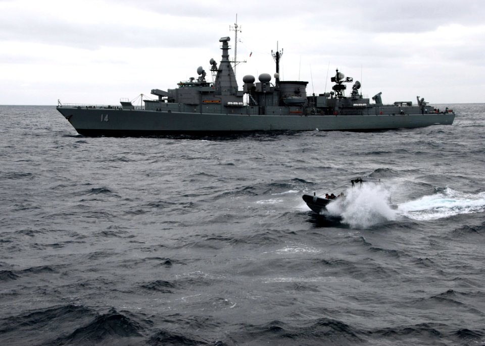 US Navy 070625-N-4021H-024 Chilean frigate CS Almirante Latorre (FFG 14) sails forward while members of her visit, board, search and seizure (VBSS) team make an approach to dock landing ship USS Pearl Harbor (LSD 52) and prepar