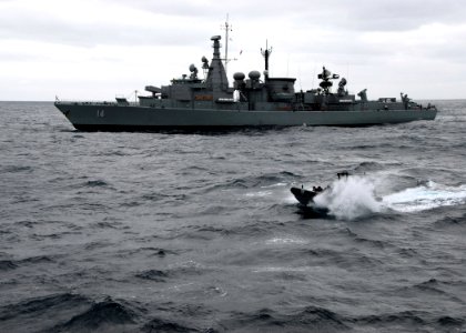 US Navy 070625-N-4021H-024 Chilean frigate CS Almirante Latorre (FFG 14) sails forward while members of her visit, board, search and seizure (VBSS) team make an approach to dock landing ship USS Pearl Harbor (LSD 52) and prepar