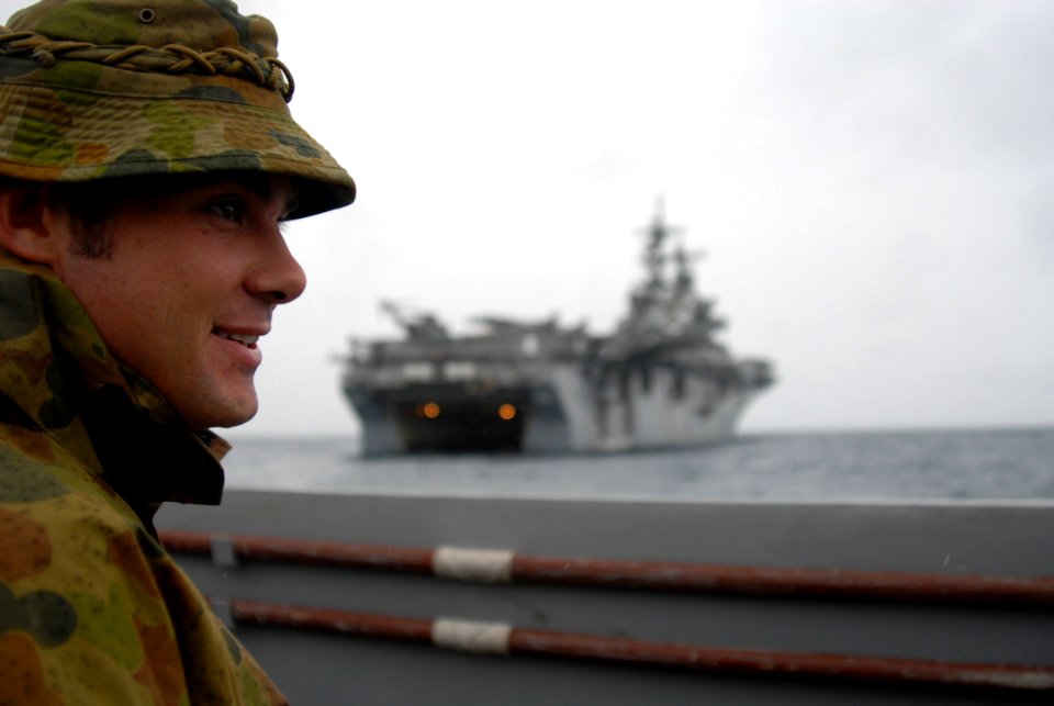US Navy 070626-N-4124C-001 Lt. Mark Gilchrist, a member of the Australian Army, is transported aboard a Landing Craft Utility (LCU) 1651 of Assault Craft Unit (ACU) 1 with amphibious assault ship USS Essex (LHD 2) in the backgr