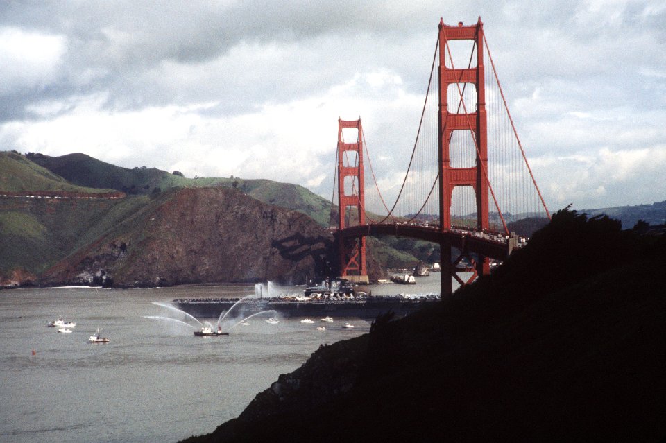 USS Coral Sea (CV-43) under the Golden Gate Bridge in 1983