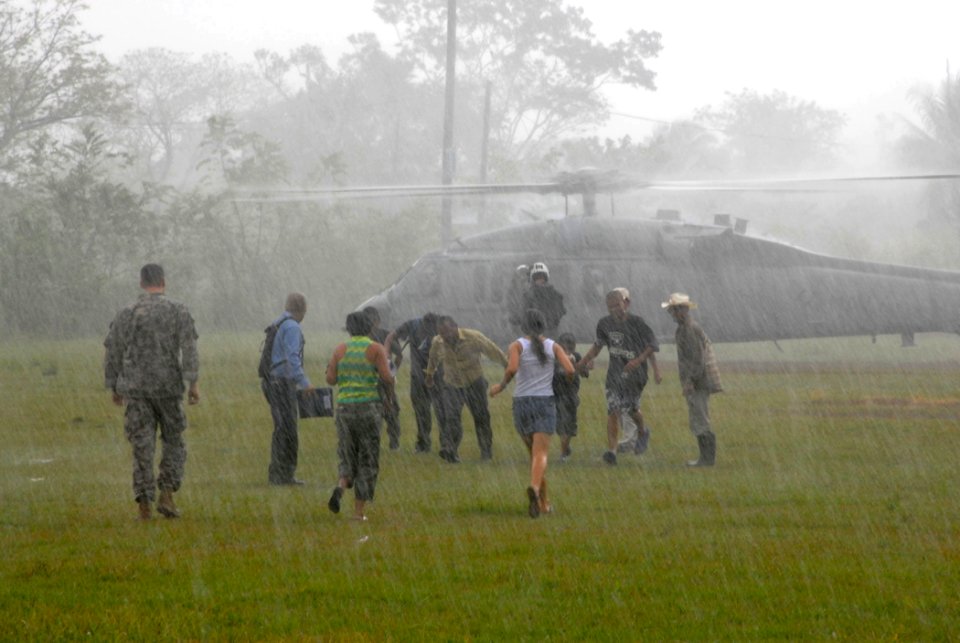 US Navy 070623-N-8704K-202 Medical patients depart a U.S. Navy MH-60S Seahawk assigned to Helicopter Sea Combat Squadron (HSC) 28 after receiving medical care and airlift from the Military Sealift Command hospital ship USNS Com