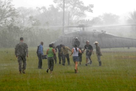 US Navy 070623-N-8704K-202 Medical patients depart a U.S. Navy MH-60S Seahawk assigned to Helicopter Sea Combat Squadron (HSC) 28 after receiving medical care and airlift from the Military Sealift Command hospital ship USNS Com photo