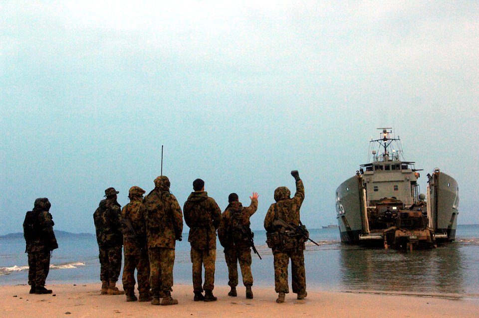 US Navy 070622-F-1644L-004 An Australian landing craft heavy prepares to offload military vehicles at Freshwater Bay with the help of U.S. Navy beach masters, assigned to Beach Master Unit (BMU) 1, during exercise Talisman Sabe