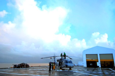 US Navy 070627-N-0194K-006 The maintenance crew assigned to Helicopter Sea Combat Squadron (HSC) 28 works on an MH-60S Seahawk aboard Military Sealift Command hospital ship USNS Comfort (T-AH 20) photo