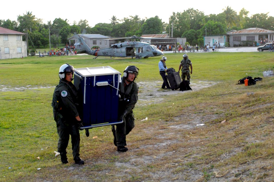US Navy 070624-N-7088A-020 Air crew personnel attached to Helicopter Sea Combat Squadron (HSC) 28 move a dental cabinet that will be filled with supplies donated by Project Handclasp to the San Pablo Roman Catholic School