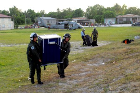 US Navy 070624-N-7088A-020 Air crew personnel attached to Helicopter Sea Combat Squadron (HSC) 28 move a dental cabinet that will be filled with supplies donated by Project Handclasp to the San Pablo Roman Catholic School