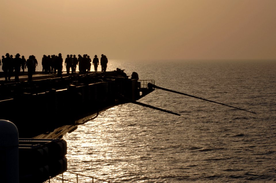 US Navy 070623-N-3729H-313 Flight deck Sailors participate in a combat foreign object damage (FOD) walk down on the flight deck of Nimitz-class aircraft carrier USS John C. Stennis (CVN 74)