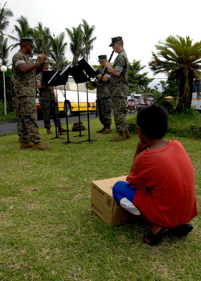 US Navy 070623-N-4954I-213 A Filipino child watches the U.S. Marine Corps Forces Pacific Band as it performs near the Ziga Memorial Hospital