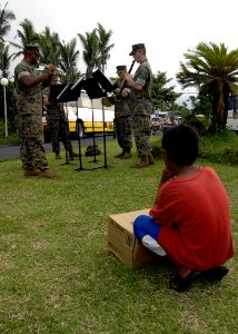 US Navy 070623-N-4954I-213 A Filipino child watches the U.S. Marine Corps Forces Pacific Band as it performs near the Ziga Memorial Hospital