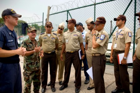 US Navy 070627-N-5319A-031 Boatswain's Mate 2nd Class Thomas Williams, U.S. Coast Guard International Training Division, Master-at-Arms 1st Class Cardona Hector, U.S. Navy interpreter, conduct a port vulnerability walkthr photo