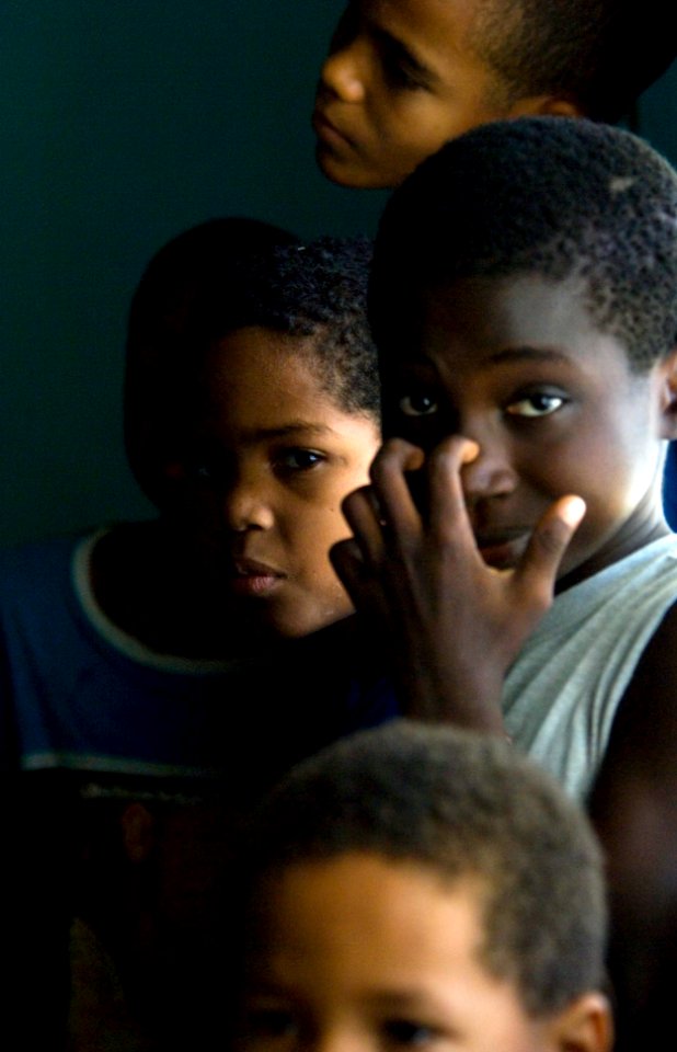 US Navy 070627-N-5319A-059 Young Dominican schoolboys watch Sailors from High Speed Vessel (HSV) 2 Swift as they come to inspect local schools for future repairs