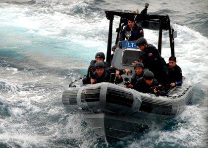US Navy 070625-N-4021H-030 Members of the Chilean frigate CS Almirante Latorre's (FFG 14) visit, board, search and seizure (VBSS) team approach the starboard side of dock landing ship USS Pearl Harbor (LSD 52), while enga