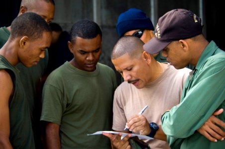 US Navy 070627-N-5319A-004 Storekeeper 2nd Class Alfonso Anglada, U.S. Navy interpreter, takes muster of the Dominican students before seamanship class starts on board High Speed Vessel (HSV) 2 Swift photo