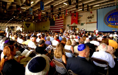 US Navy 070624-N-5345W-084 Hundreds of guests in the hangar bay of the Nimitz-class aircraft carrier USS Harry S. Truman (CVN 75) listen as Michigan Senator Carl Levin (D), Chairman of the Senate Armed Services Committee, deliv