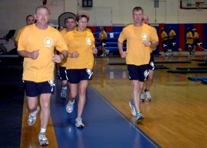US Navy 070627-N-8053S-008 Senior enlisted leaders attending the Master Chief Petty Officer of the Navy's (MCPON) Leadership Mess Meeting participate in a jog around the gymnasium photo