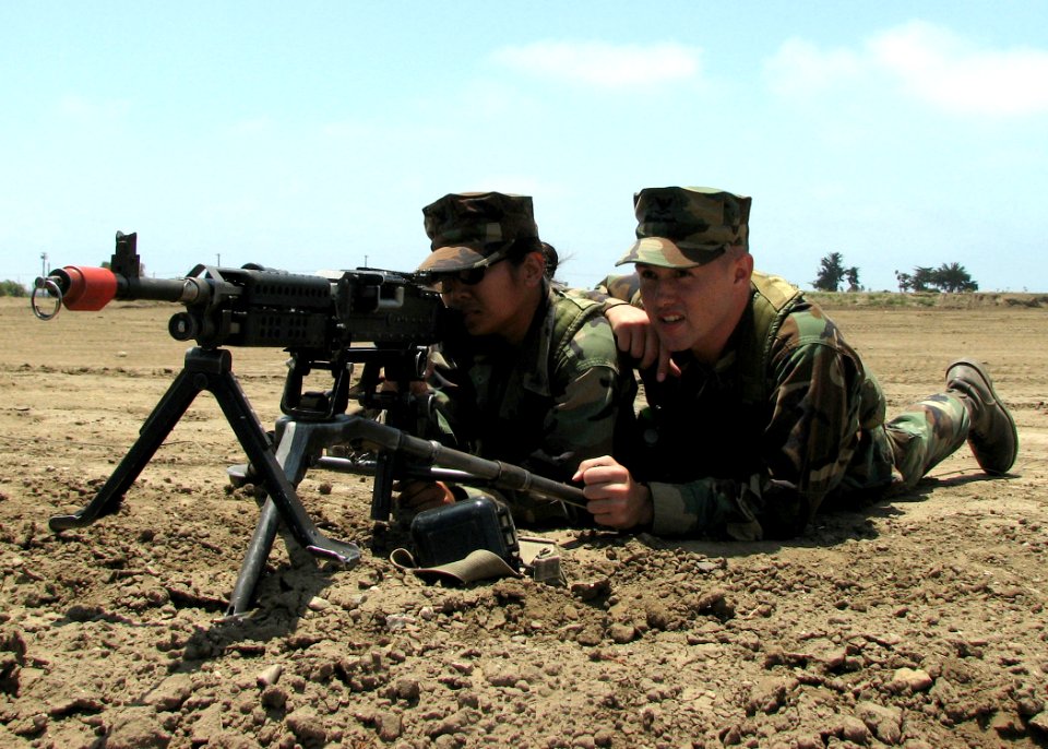 US Navy 070627-N-8547M-003 Engineers Aide 3rd Class Marie Buencilla and Equipment Operator 3rd Class Derek Prez, of Naval Mobile Construction Battalion (NMCB) 5, man a M240B machine gun