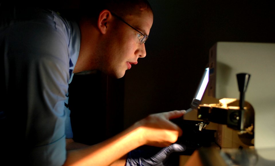US Navy 070628-N-0194K-314 Hospital Corpsman 3rd Class Edward Mace, attached to Military Sealift Command hospital ship USNS Comfort (T-AH 20), crafts new eyeglass lenses at the Puerto Barrios National Hospital