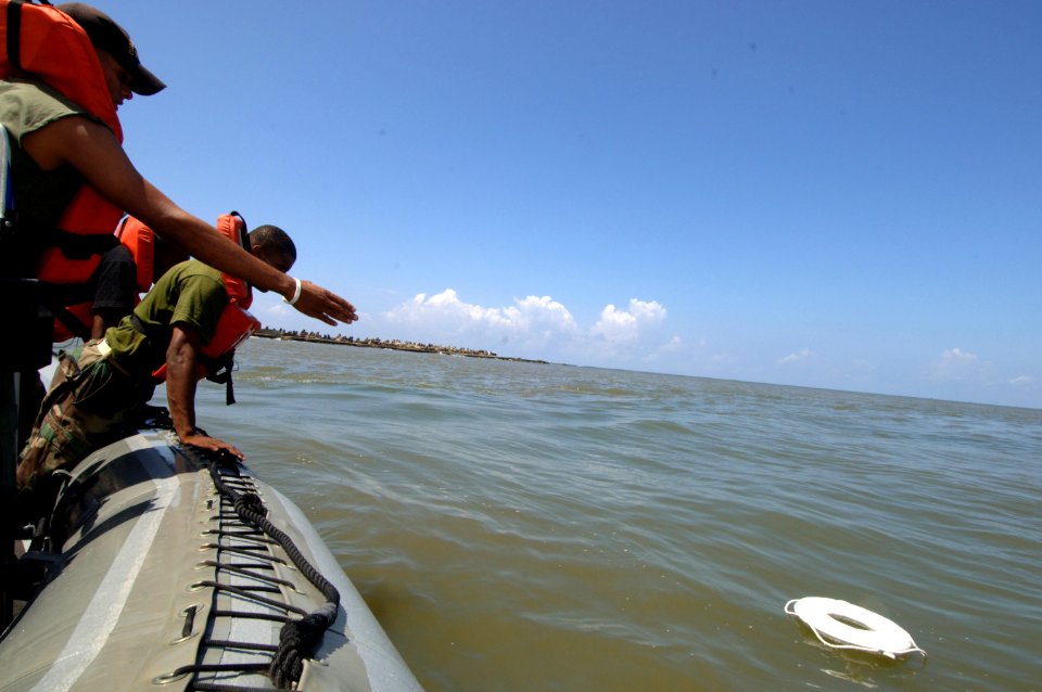 US Navy 070629-N-0989H-101 Members from the Dominican Republic army practice man overboard recovery drills during coxswain subject matter exchanges photo