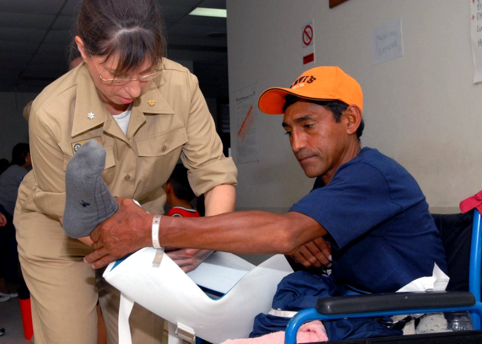 US Navy 070629-N-4238B-031 Cmdr. Patricia Corley, a clinical nurse assigned to Military Sealift Command hospital ship USNS Comfort (T-AH 20), wraps the leg of a patient at Puerto Barrios National Hospital