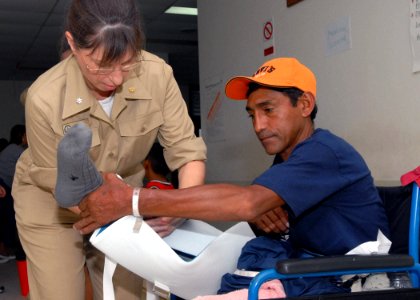US Navy 070629-N-4238B-031 Cmdr. Patricia Corley, a clinical nurse assigned to Military Sealift Command hospital ship USNS Comfort (T-AH 20), wraps the leg of a patient at Puerto Barrios National Hospital