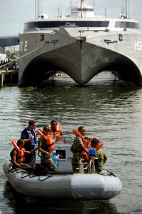 US Navy 070627-N-5319A-037 Chief Boatswain's Mate William Partington, Coast Guard International Training Division, and Storekeeper 2nd Class Alfonso Anglada, U.S. Navy interpreter, conduct small boat training with the Dominican photo