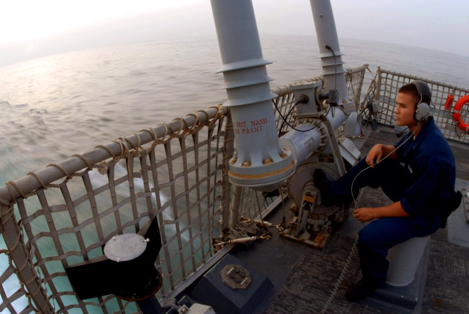 US Navy 070630-N-7498L-076 Seaman Carlos Cano stands aft lookout on the fantail aboard guided-missile destroyer USS O'Kane (DDG 77)