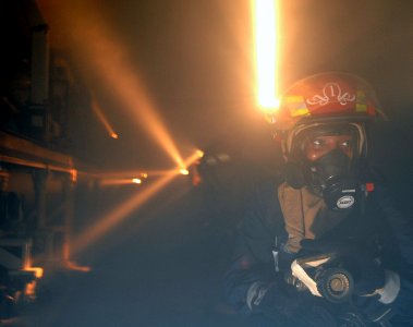 US Navy 070630-N-3729H-061 Damage Controlman 3rd Class Letitia Gwathney participates in a fire drill in aircraft intermediate maintenance department's jet engine repair shop aboard Nimitz-class aircraft carrier USS John C. Sten