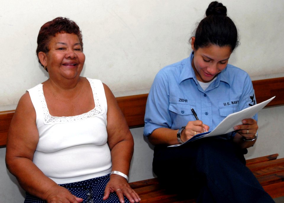 US Navy 070629-N-4238B-100 Hospital Corpsman 1st Class Wanda Ziehr, a patient administrator for the Military Sealift Command (MSC) hospital ship USNS Comfort (T-AH 20), shares a laugh with a patient at Puerto Barrios National H