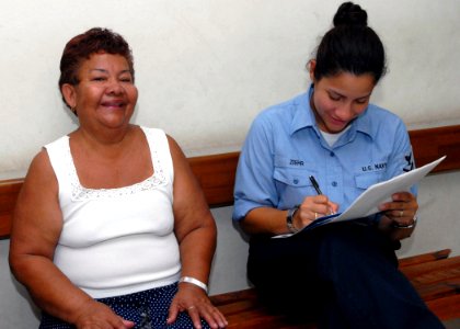 US Navy 070629-N-4238B-100 Hospital Corpsman 1st Class Wanda Ziehr, a patient administrator for the Military Sealift Command (MSC) hospital ship USNS Comfort (T-AH 20), shares a laugh with a patient at Puerto Barrios National H photo