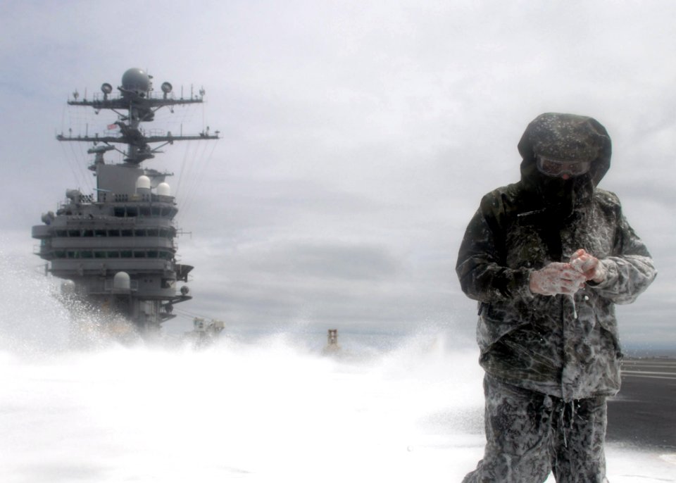 US Navy 070627-N-1229B-101 A member of engineering department takes a test sample of aqueous film forming foam (AFFF) during an AFFF countermeasure wash down aboard Nimitz-Class aircraft carrier USS Abraham Lincoln (CVN 72)