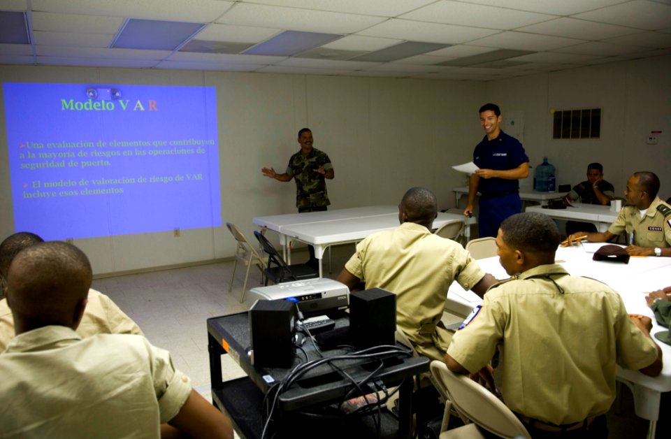 US Navy 070627-N-5319A-025 Chief Boatswain's Mate William Partington, Coast Guard International Training Division, and Storekeeper 2nd Class Alfonso Anglada, U.S. Navy interpreter, conduct small boat training with the Dominican photo