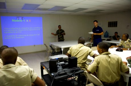 US Navy 070627-N-5319A-025 Chief Boatswain's Mate William Partington, Coast Guard International Training Division, and Storekeeper 2nd Class Alfonso Anglada, U.S. Navy interpreter, conduct small boat training with the Dominican