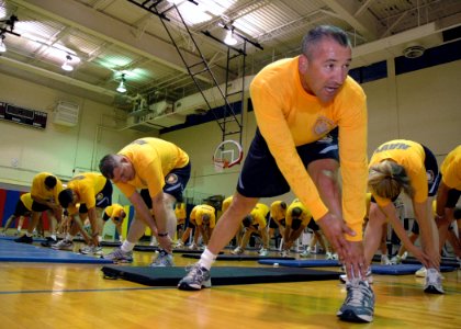 US Navy 070627-N-1328C-035 1st Marine Logistics Group (1st MLG) Command Master Chief (CMDCM) German Fiesco and other Navy senior enlisted leaders stretch, as they wear-test the Navy's proposed physical training uniform photo