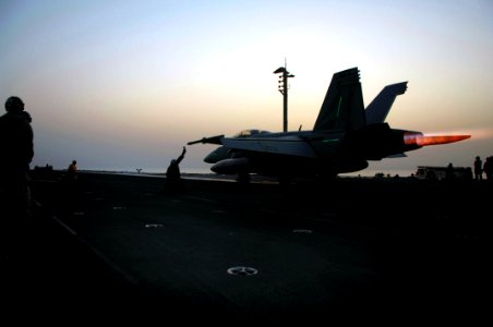 US Navy 070630-N-3729H-016 An F-A-18F Super Hornet, attached to the Black Knights of Strike Fighter Squadron (VFA) 154, goes to afterburner prior to launching from the flight deck of Nimitz-class aircraft carrier USS John C. St