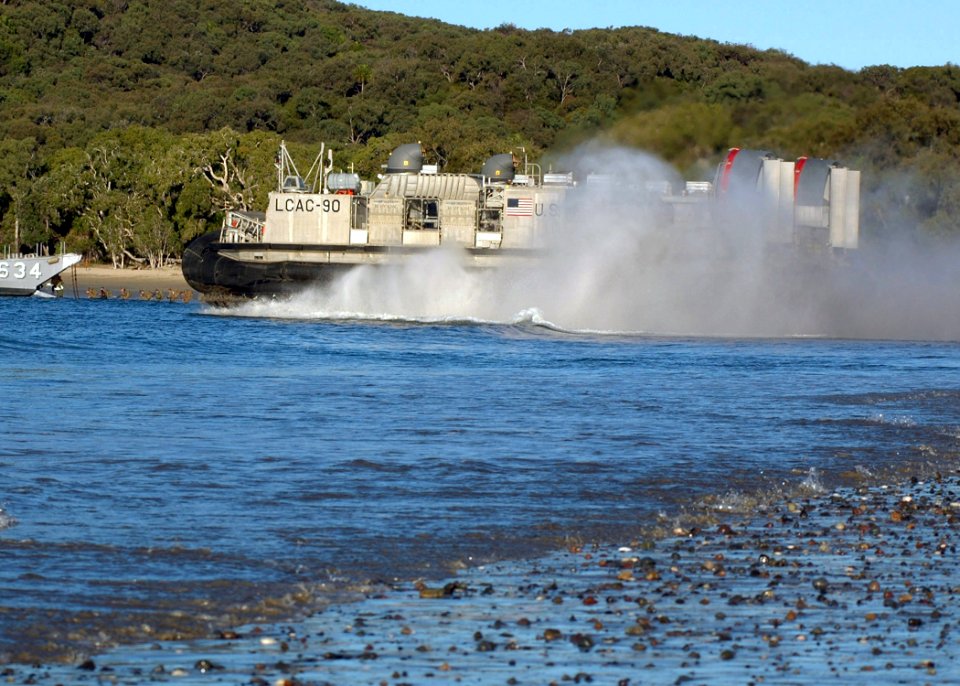 US Navy 070628-N-6710M-081 A Landing Craft Air Cushion (LCAC) from Assault Craft Unit (ACU) 5 makes its way from the beach to drop off Marine cargo and supplies at the conclusion of the field training phase of Talisman Saber 20