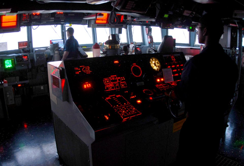 US Navy 070630-N-7498L-118 Seaman Alexander Chance minds the helm as he steers guided-missile destroyer USS O'Kane (DDG 77) through the Persian Gulf