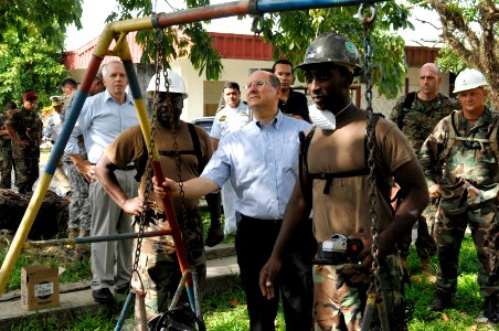 US Navy 070627-N-3642E-559 Secretary of the Navy (SECNAV) The Honorable Dr. Donald C. Winter looks at a swing set being repaired by Seabees