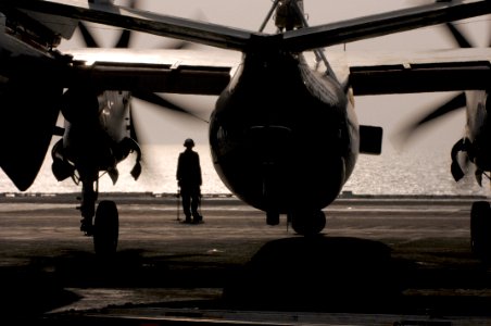 US Navy 070702-N-3729H-199 An E-2C Hawkeye powers down its engines while a plane captain waits to secure the aircraft after landing aboard Nimitz-class aircraft carrier USS John C. Stennis (CVN 74)