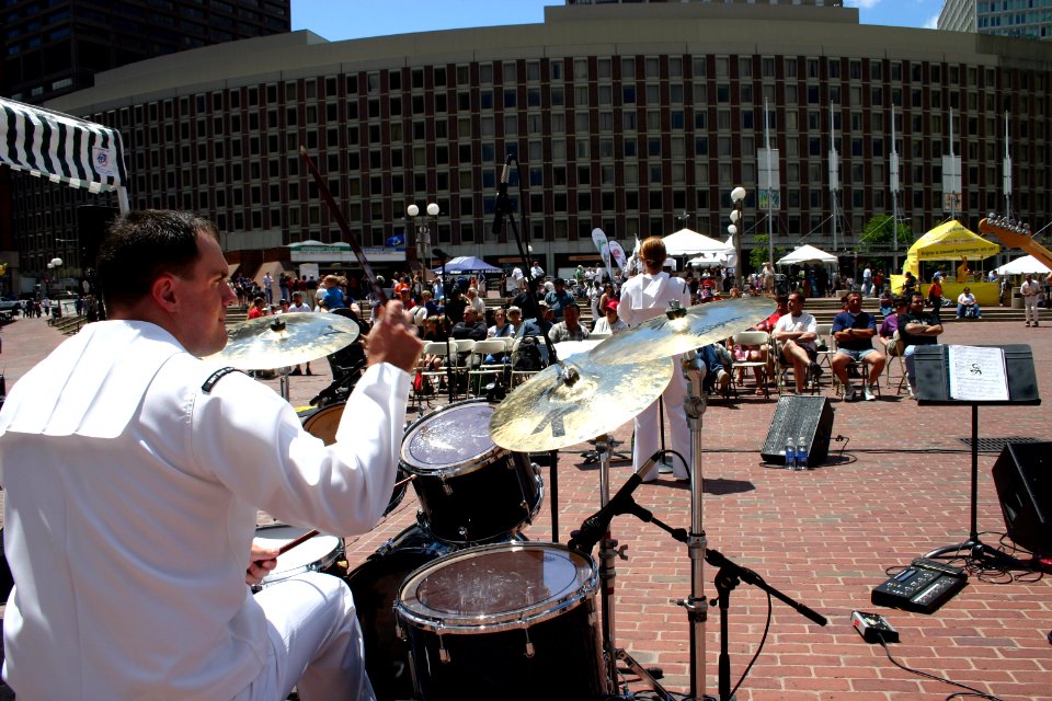 US Navy 070630-N-8110K-002 Musician 1st Class Jason Robertson, band leader and drummer for Navy Band Northeast's eight member rock group Rhode Island Sound, entertains the Boston Harborfest crowd in City Hall Plaza