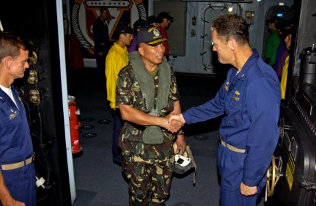 US Navy 070627-N-6410J-116 Lt. Gen. Alexander Yano, Chief of the Southern Luzon Command (SOLCOM), shakes hands with Capt. Ed Rhoades, commanding officer of amphibious assault ship USS Peleliu (LHA 5)
