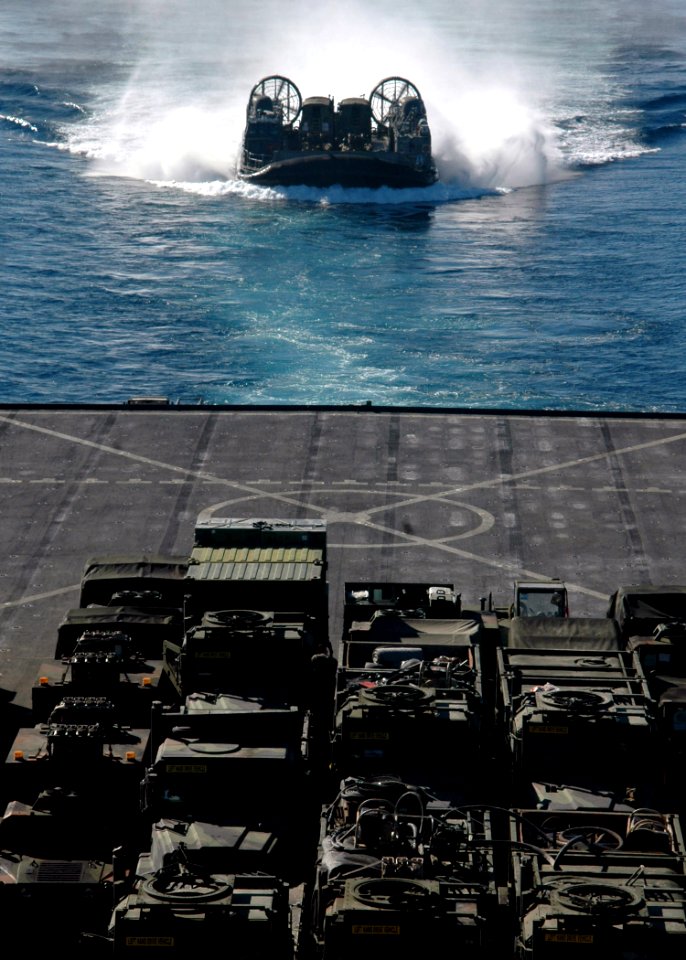 US Navy 070702-N-6710M-015 A landing craft air cushion (LCAC) prepares to enter the well deck of dock landing ship USS Tortuga (LSD 46) while carrying supplies and cargo from the 31st Marine Expeditionary Unit