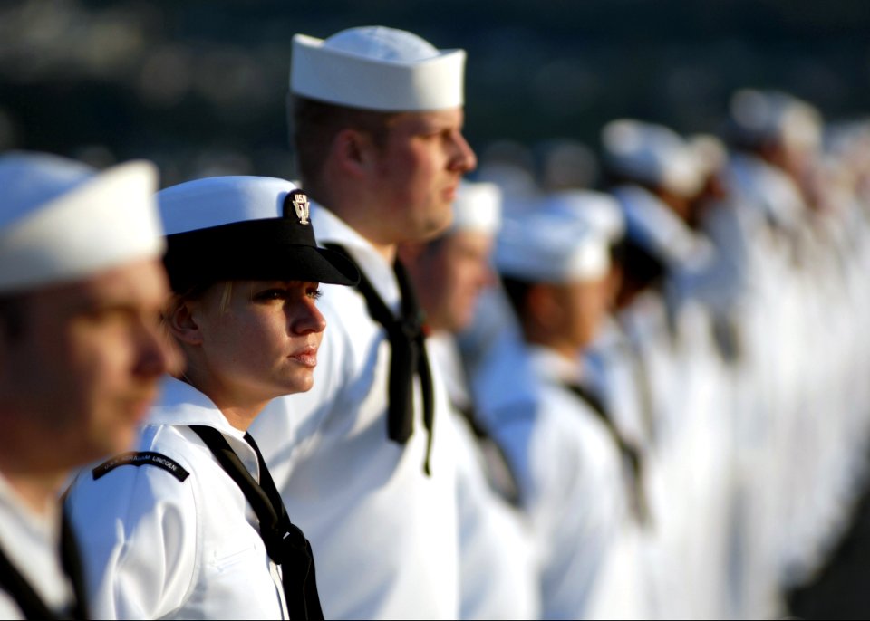 US Navy 070630-N-7981E-649 Yeoman 3rd Class Erika Rice and other Sailors man the rails as Nimitz-class aircraft carrier USS Abraham Lincoln (CVN 72) pulls into her homeport at Naval Station Everett