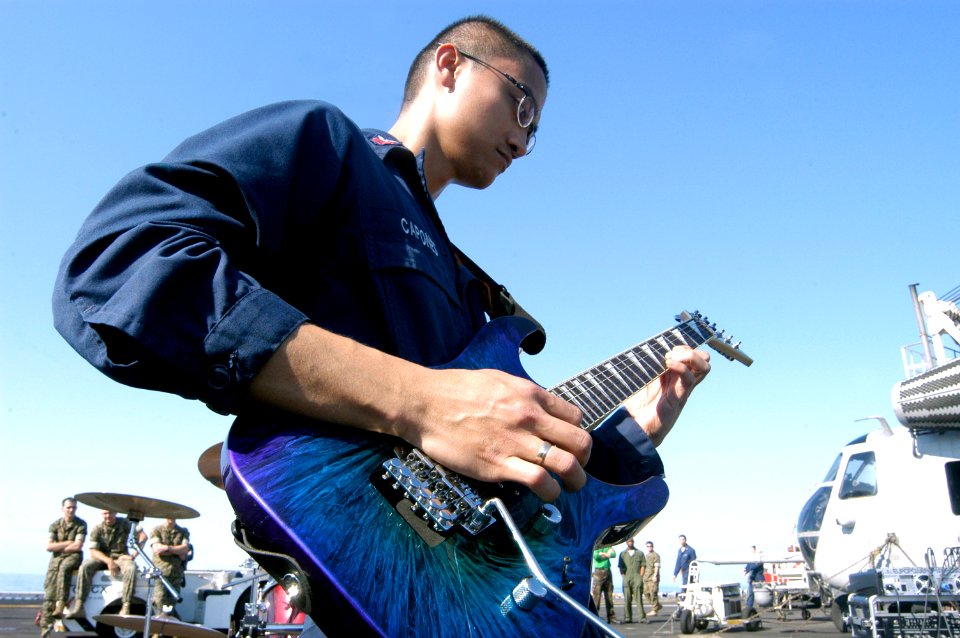 US Navy 070627-N-8154G-014 Store Keeper 1st Class Ronneil Capones, a member of the multi-purpose amphibious assault ship USS Bataan ship band The Ascended performs on the flight deck