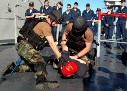 US Navy 070702-N-6710M-028 Members of the visit, board, search and seizure (VBSS) team aboard USS Tortuga (LSD 46) demonstrate the proper weapons tactics for a group of embarked midshipman