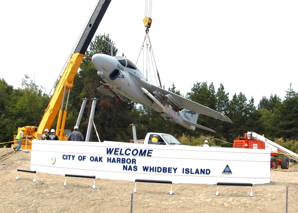 US Navy 070628-N-6247M-005 An A-6 Intruder is lowered by a crane into place at the gateway display on Highway 20 at the north end of the city