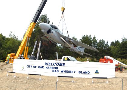 US Navy 070628-N-6247M-005 An A-6 Intruder is lowered by a crane into place at the gateway display on Highway 20 at the north end of the city