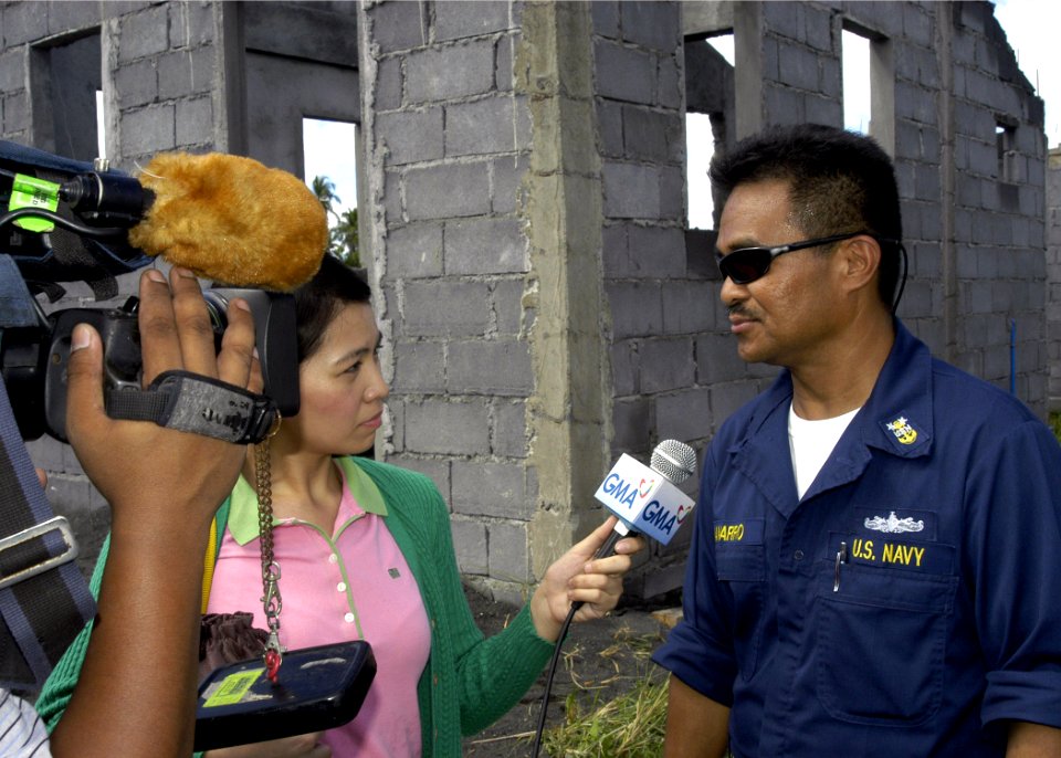 US Navy 070628-N-1752H-035 Master Chief Machinist's Mate Gamaliel Navarro answers questions from local media about what the Navy is doing in support of the Pacific Partnership mission